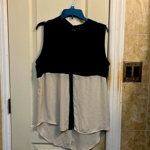 Size large women’s sleeveless semi sheer blouse.